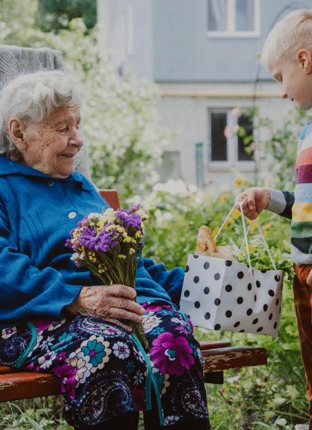 lady in wheelchair with bunch of wildflowers